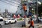 Man on a bamboo ladder leans against the power line