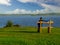 Man in baseball hat sitting on a wooden bench looking at lake Corrib and cloudy sky. Concept relaxation, meditation