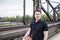 Man With a Basketball Posing Near Railway Tracks