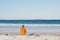 Man at beach looks out over the ocean, Bremer Bay, Western Australia