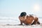 Man, beach and pushup on sand for fitness, workout or exercise for mockup space in summer sunshine. Young guy