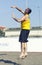 Man beach volleyball player serving ball jumping