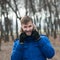 Man with a beard adjusts his hood