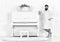 Man with beard in bathrobe enjoys morning while standing near piano. Talented musician concept. Man serious stands and