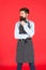 Man with beard cook hipster apron. Hipster chef cook red background. Bearded man chef cooking. Restaurant staff and