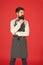Man with beard cook hipster apron. Hipster chef cook red background. Bearded man chef cooking. Restaurant staff and