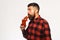 Man with beard drinks tomato juice isolated on white background.