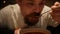 Man with a beard eating borsch with sour cream. red-beet soup. borsh