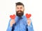 Man with beard with happy face hold red paper hearts