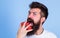 Man beard hipster strawberries fingers blue background. Mostly carbohydrates sucrose fructose glucose. Carbohydrate