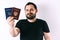 A man with a beard holding a passport of Russia and Ukraine translation: - Ukraine. Passport, Russian Federation