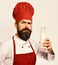 Man with beard holds bottle of milk on white background.