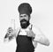 Man with beard holds bottle of milk on white background. Chef with milkshake or yoghurt shows thumbs up