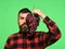 Man with beard holds bunch of grapes isolated on green