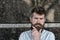 Man with beard and mustache on concentrated face, black marble background. Masculinity concept. Hipster with tousled