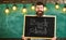 Man with beard and mustache on happy face welcomes colleagues, chalkboard on background. Hiring teachers concept