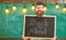 Man with beard and mustache on happy face welcomes colleagues, chalkboard on background. Hiring teachers concept