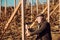 Man with beard and mustache work with axe. Portrait of aged man. Professional work with axe. Bearded man repair vineyard