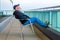 Man with beard sitting in chair on balcony