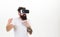 Man with beard in VR glasses fighting, white background. VR gadget concept. Hipster on busy face exploring virtual