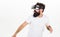 Man with beard in VR glasses run away , white background. VR game concept. Guy with head mounted display run in virtual