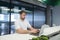 A man with a beard works at a laptop in the office. A young man enjoys a computer in a modern office.