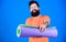 Man bearded athlete hold fitness mat. Fitness and stretching. Having good stretch. Athlete yoga coach motivated for