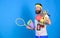 Man bearded athlete hold sport equipment jump rope fitness mat boxing glove expander racket and golden goblet. Choose