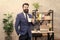 Man bearded businessman hold coffee cup stand office background. Drinking coffee relaxing break. Boss enjoying energy