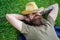 Man bearded cowboy lay on grass relaxing or having nap. Cowboy relaxing at green meadow. Brutal cowboy with green