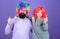 Man bearded father and girl wear colorful wig while eat lollipop candy. Thing loving father do for children. Tribute to