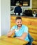 Man bearded guy drinks cappuccino wooden table cafe. Cafe visitor happy smiling face enjoy coffee drink. Improve overall