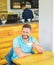 Man bearded guy drinks cappuccino wooden table cafe. Cafe visitor happy smiling face enjoy coffee drink. Improve overall