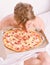 Man bearded handsome guy eating cheesy food for breakfast in bed. Shirtless handsome young man with pizza on bed