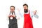 Man bearded hipster and mature chef apron white background. Working hours and lunch break. Lack of time. Check what time