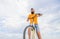 Man bearded hipster rides bicycle bottom view sky background. Overcome obstacles on bike. Hipster ready to perform trick