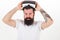 Man bearded hipster with virtual reality headset on white background isolated. Sensational feelings of using VR headset