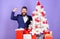 Man bearded hipster wear formal suit near christmas tree. Christmas gifts and decorations. How to organize awesome