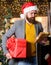 Man bearded hipster wear santa hat hold bunch of letters and gift box. Post for santa claus. Letter for santa claus. Man