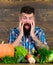 Man bearded look at harvest wooden background. Farmer with homegrown crops on table. Vegetables organic harvest. Farmer
