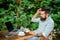 Man bearded manager entrepreneur sit terrace outdoors with laptop and cup of coffee. Create content for web blog