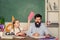 Man bearded pedagogue study together with kid. Discipline and upbringing. Reward and punishment principle. Help study