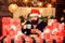 Man bearded santa claus hat reading letters. Generous new year. Lot of gifts. Happy winter holidays. Wrapped gifts with