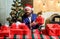 Man bearded santa prepared christmas gifts. Businessman near christmas tree wrapping presents or gift boxes. Which is