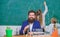 Man bearded teacher work with microscope and test tubes in biology classroom. Biology plays role in understanding of