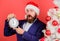 Man bearded wear suit and santa hat hold clock. Businessman join christmas celebration. Last minute deals. Counting time