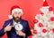Man bearded wear suit and santa hat hold clock. Last minute deals. Counting time till christmas. How much time left