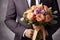 Man with beautiful bouquet on grey background, closeup. Wedding day