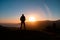 Man in beautiful inspiring sunrise with mountains and sea.