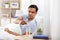 Man in bed dropping medicine into glass of water